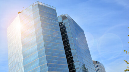 Office building, details of blue glass wall and sun reflections.