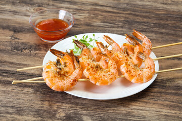 Grilled prawn skewer with sauce