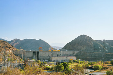 Obraz premium Dam in the mountains in Central Asia. View of a levee in the gorge. 