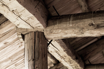 Old wooden roof Internal construction. Rough logs
