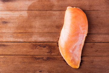 Raw fresh chicken breast fillets uncooked studio shot on wooden table background