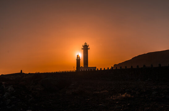 Silhouette of the Fuencaliente Lighthouse at sunset, on the route of the volcanoes south of the island of La Palma, Canary Islands, Spain