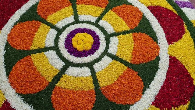 Home made Flower bed decoration or Pookalam, on Onam, Vishu, Diwali celebration of Kerala, India. Indian harvest festival. tropical fresh flowers.