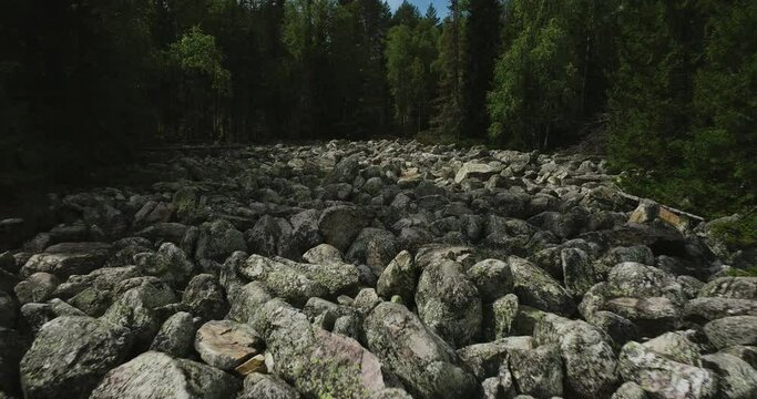 Stone river in South Ural /  place of difficult hiking, active lifestyle, explore and discover concept in rocky valley. Aerial drone wide shot at summer sunny day