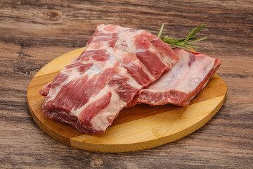Raw pork ribs served rosemary