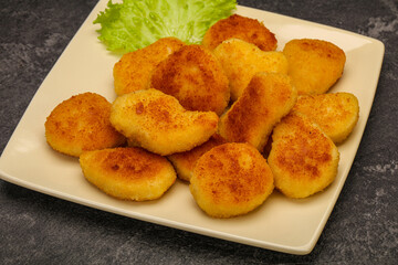 Fried chicken nuggets served salad leaves
