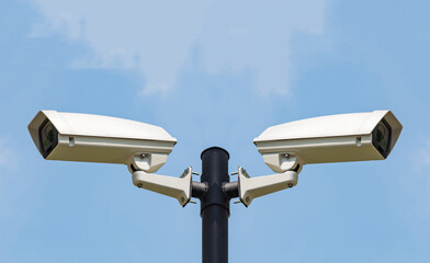 Two CCTV Security camera on clear sky background