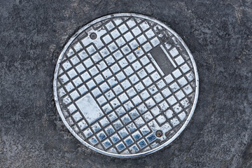 Closeup photo of Old Sewer manhole cover on white background