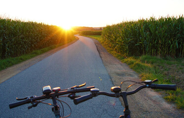 Fototapeta na wymiar cycling together towards the sunset