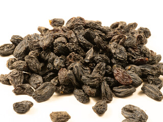 Black raisins on a white background