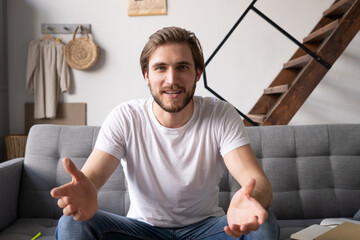 Young guy speaking recording vlog at home looking at camera webcam, male vlogger talking shooting video blog webinar making online call, communicating having distant job interview e-coaching teaching