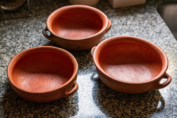 Ceramic pottery. Beautiful clay utensils with decorative ornament. Kitchenware, ceramic dishes for cooking, storage eating, rustic pottery. Clay saucepan and frying pan