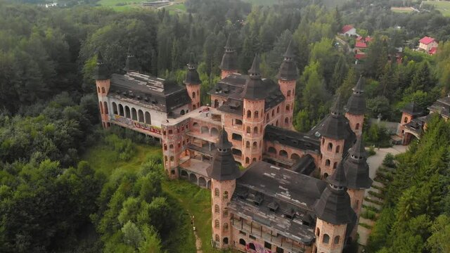 People exploring unfinished castle in the forest in Lapalice, Poland