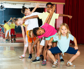 Happy children having fun in a choreography studio during dance lesson