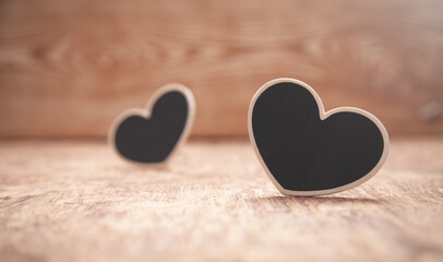 Wooden hearts on wooden table.