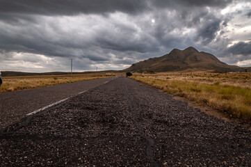 The old Gold's Road at highest point in San Luis, Argentina, which climbs steppe mountains while a heavy storm is coming