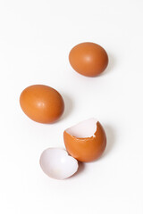 Fresh chicken whole eggs and a broken egg isolated on white background.