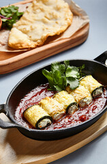 Eggplant rolls with cheese in tomato sauce