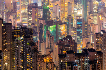 Close up modern high rise building view from the Victoria peak at night time in Hong Kong.