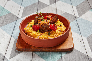 Hummus with beef served in brown bowl