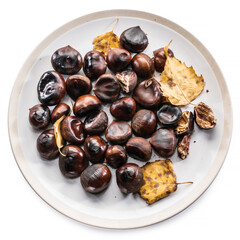 Roasted edible chestnut fruits isolated on the plate. Top view.