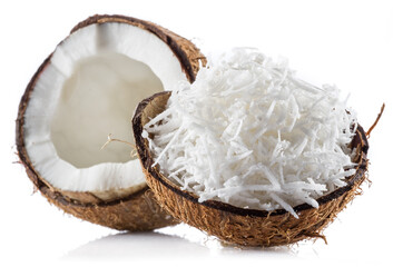 Coconut fruit and shredded coconut flakes in the piece of shell isolated on white background.