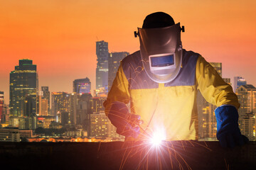 Industrial Welder with safety equipments and protective mask welding steel structure in...