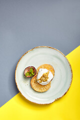 Pineapple slices with maracuya sauce top view