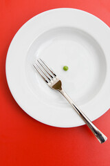 green pea and fork on plate