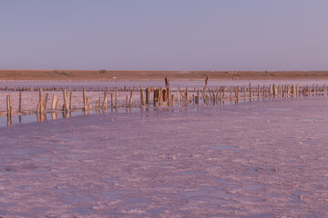 Pink salt lake at the site of an abandoned salt plant at sunset