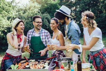 Friends having fun in nature doing bbq