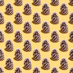 New Year seamless pattern with pinecone on yellow background.