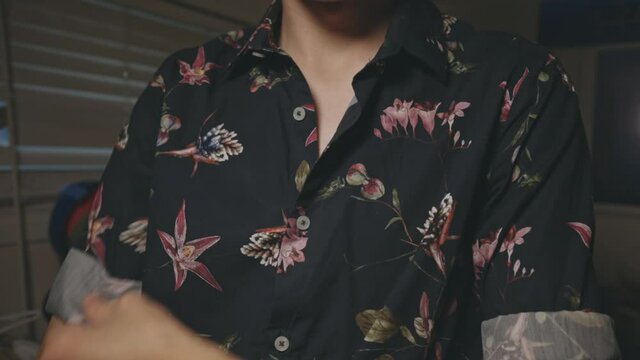 Man Neatly Wearing A Casual Black Floral Button-Up Shirt - Closeup Shot