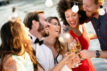 Group of happy people or friends having fun at party