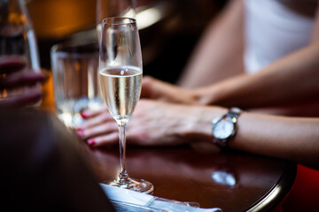 Glass of champagne on the table in a dark restaurant