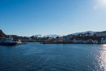 Fototapeta na wymiar Approaching the city of Ålesund with the post ship on a clear winter day