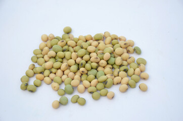 the green brown soya been lentils isolated on white background.