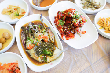 Top view image of Korean traditional cuisine on table, soy sauce marinated crab with a lot of side dishes