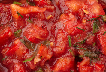 Closeup texture red tomato sauce with herbs