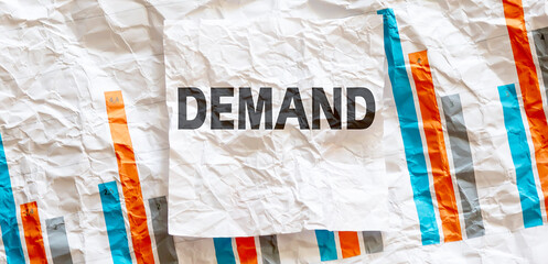 DEMAND word text on the white memo note crupled sticker on chart background