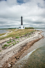 Fototapeta na wymiar Sightseeing of Saaremaa island. Sõrve lighthouse is a popular landmark and scenic location on the Baltic sea coast