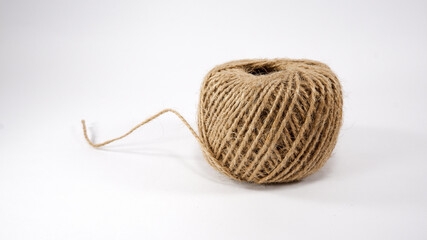Roll of jute twine for crafting on white background
