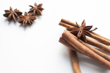 spices for making mulled wine (star anise and cinnamon) on a white background