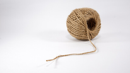 Roll of jute twine for crafting on white background