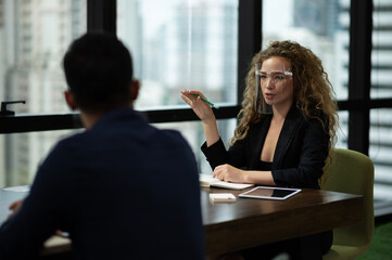 Beautiful business women conference with team in office wearing proptection face mask.