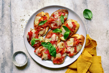 Grilled bruschetta with tomato and mozzarella. Top view with copy space.