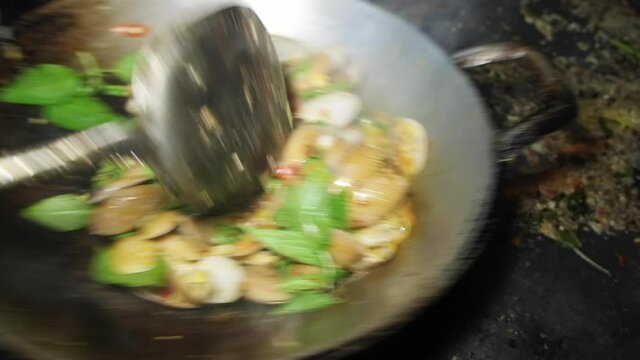 Close up Cooking Thai seafood Stir Fried Clams with Roasted Chili paste on frying pan in the kitchen thai restaurant