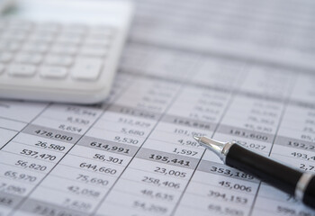 pen, calculator and business analysis report on desk of financial advisor. financial accounting concept.