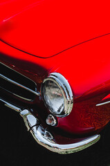 Vintage old red car headlight detail. Retro car lamp.