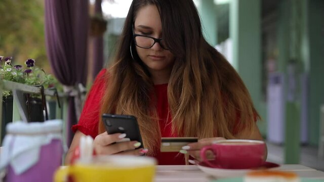 Woman rewrite number of credit card into smartphone, online shopping concepts